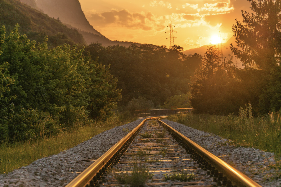 Image of train tracks at sunset